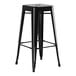 A black metal Lancaster Table & Seating barstool with a black square seat.