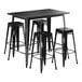 A Lancaster Table & Seating black bar height table with four black backless barstools.