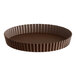 A brown round Gobel tart pan with fluted edges and a removable bottom.