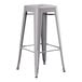 A Lancaster Table & Seating gray metal barstool with a black seat.