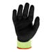 A black glove with a yellow stripe and green nitrile palm coating.