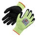 A pair of black and lime green Ergodyne ProFlex warehouse gloves with WSX nitrile palm coating and a label.