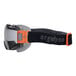 An Ergodyne Skullerz MODI safety goggle with a black and orange strap.