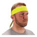 A man wearing a lime green Ergodyne cooling bandana.