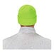 A person wearing a hi-vis lime green Ergodyne cuffed rib knit winter hat.