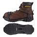 A brown caterpillar work boot with black straps and a TREX 6325 traction device attached.