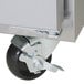 A Traulsen stainless steel sandwich prep table with right hinged doors and wheels.