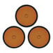 A close-up of three black and orange circle pads.