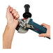 A hand holding a blue Ergodyne tool tether attached to a Bosch power tool.