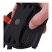 A hand holding a black Ergodyne Squids arm and wrist scanner mount strap.