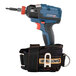 A black Ergodyne bag with a metal clip attached to a blue and black cordless drill.