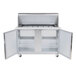A stainless steel Traulsen refrigerated counter with open left and right doors.