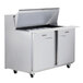 A Traulsen stainless steel sandwich prep table with one left hinged and one right hinged door open.