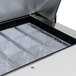 A Traulsen stainless steel sandwich prep table with clear plastic containers and a metal tray inside.