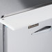 The left and right stainless steel doors of a Traulsen refrigerated sandwich prep table.