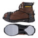 A brown work boot with a pair of Ergodyne spikeless traction devices attached.