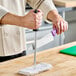 A person using a Choice stainless steel knife sharpener to sharpen a knife.