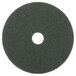 A green Scrubble 20" circular floor pad with a hole in the middle.
