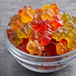 A bowl of Black Forest gummy bears on a table.