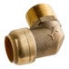 A gold metal SharkBite pipe fitting.