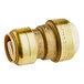 A brass SharkBite transition coupling with white plastic ends.