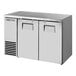 A True back bar refrigerator with stainless steel doors open.