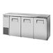 A stainless steel True back bar refrigerator with three doors open.