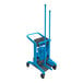 A Vikan blue and black mobile cleaning station with a blue mop and bucket and a brush.