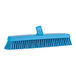 A blue Vikan push broom head with soft / stiff bristles.