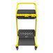 A yellow and gray Vikan HyGo mobile cleaning station with two baskets.