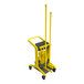 A yellow Vikan mobile cleaning station with a black handle.