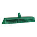 A Vikan green heavy-duty broom head with soft and stiff bristles.