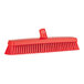 A red Vikan heavy-duty broom head with soft/stiff bristles.