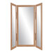 A BrandtWorks trifold dressing mirror with a wooden frame.