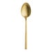 A gold Varick Lissome stainless steel teaspoon with a long handle.