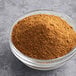 A clear bowl of McCormick Culinary Ground Cumin.