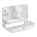 A white plastic Tork toilet paper dispenser box with a lid.