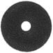 A black circular Scrubble super stripping floor pad with a hole in the center.