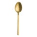 A gold Varick Lissome dessert spoon with a long handle.