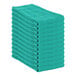 A stack of hunter green Monarch Brands huck towels.
