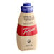 A close up of a Torani Sugar-Free White Chocolate Flavoring Sauce bottle with a blue lid.