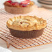 A pie in a Solut Kraft paper baking cup with flange on a cooling rack.