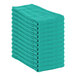 A stack of hunter green Monarch Brands huck towels.