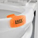 A white toilet seat with a Lavex Citrus Scent Gel Toilet Bowl Clip on it.