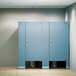 An ASI Accurate Partitions black phenolic bathroom stall with two doors.