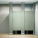An ASI Accurate Partitions black core phenolic bathroom stall with two doors enclosing a toilet.