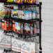 A Regency wall-mounted wire shelf with snacks on it.