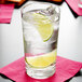 a glass of water with ice and lime slices