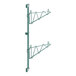 A green metal Regency wall-mount shelf post with two shelves on it.