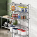 A Regency chrome wire shelf with white and blue plastic containers on it.